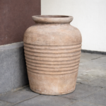 Weathered terracotta jar by the wall